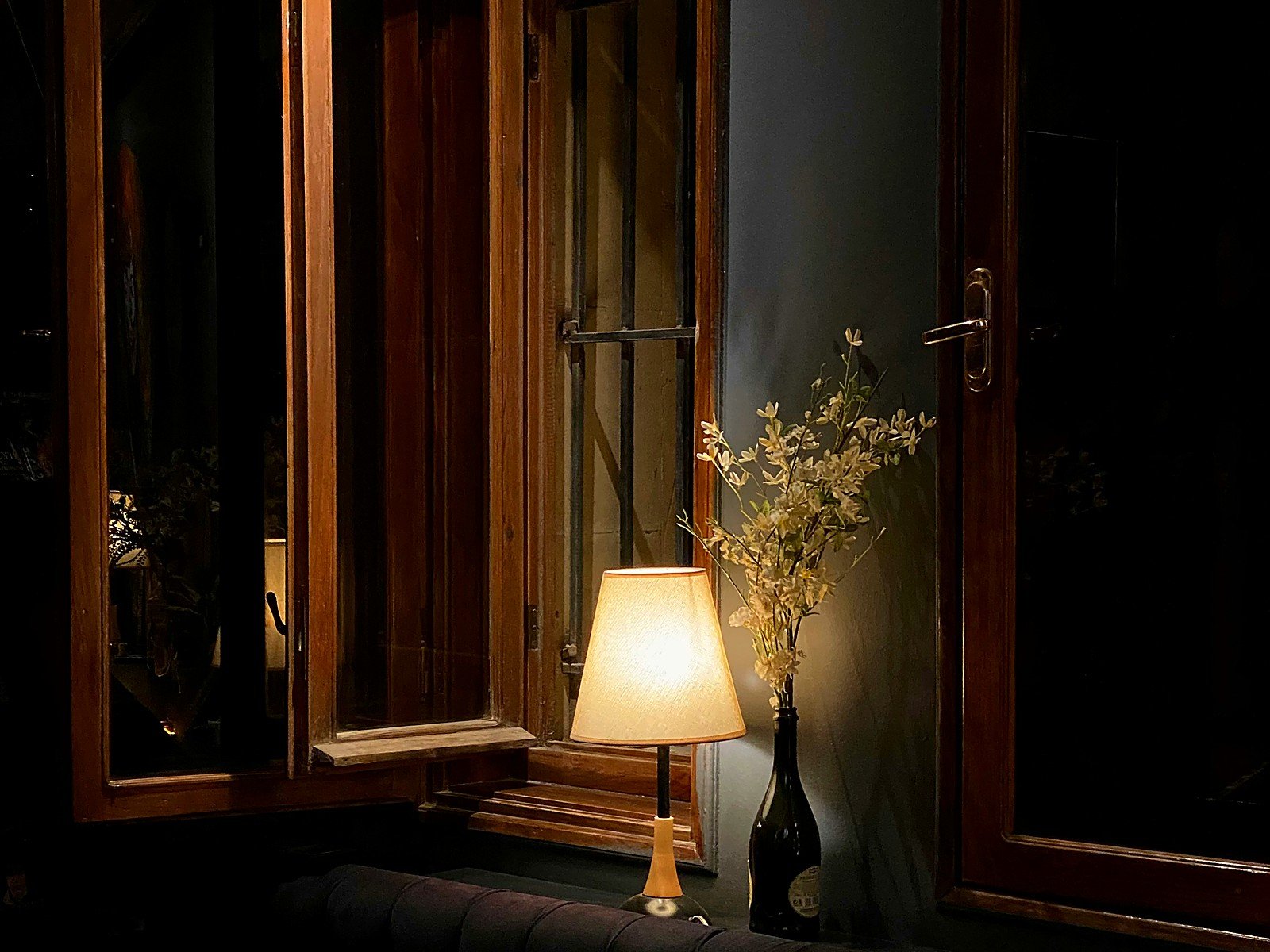 Warm lamplight beside an open window — an ambient interior detail